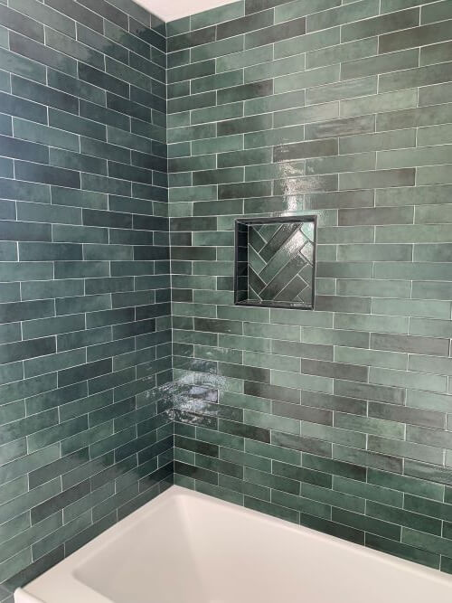 Bathtub with green tiles.