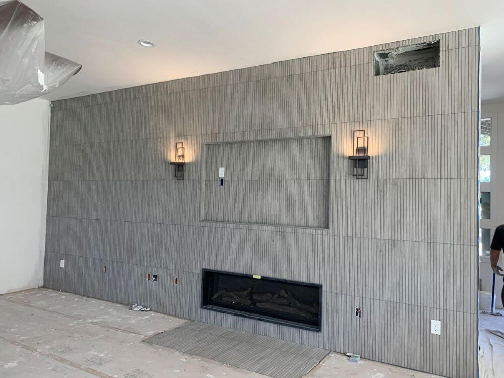 Slatted wood-look porcelain tile fireplace.