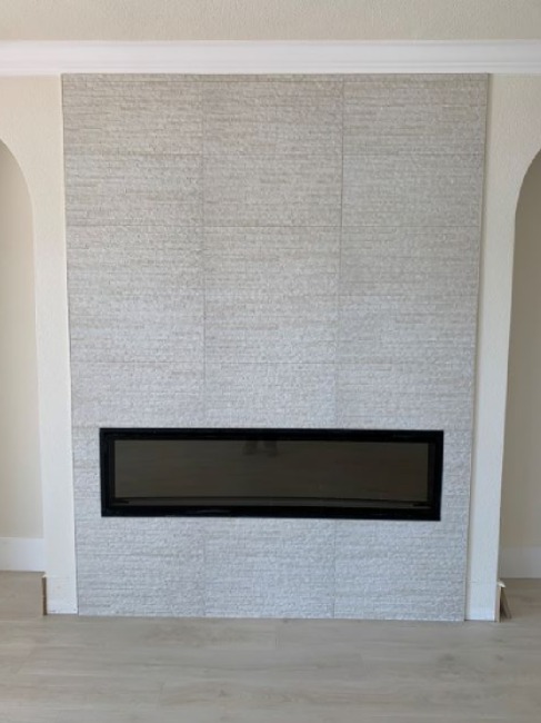 Stone look porcelain tiled fireplace.