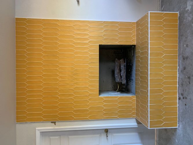 Fireplace with yellow picket ceramic tile.