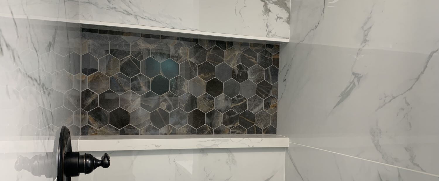Shower niche with haxagon tiles.