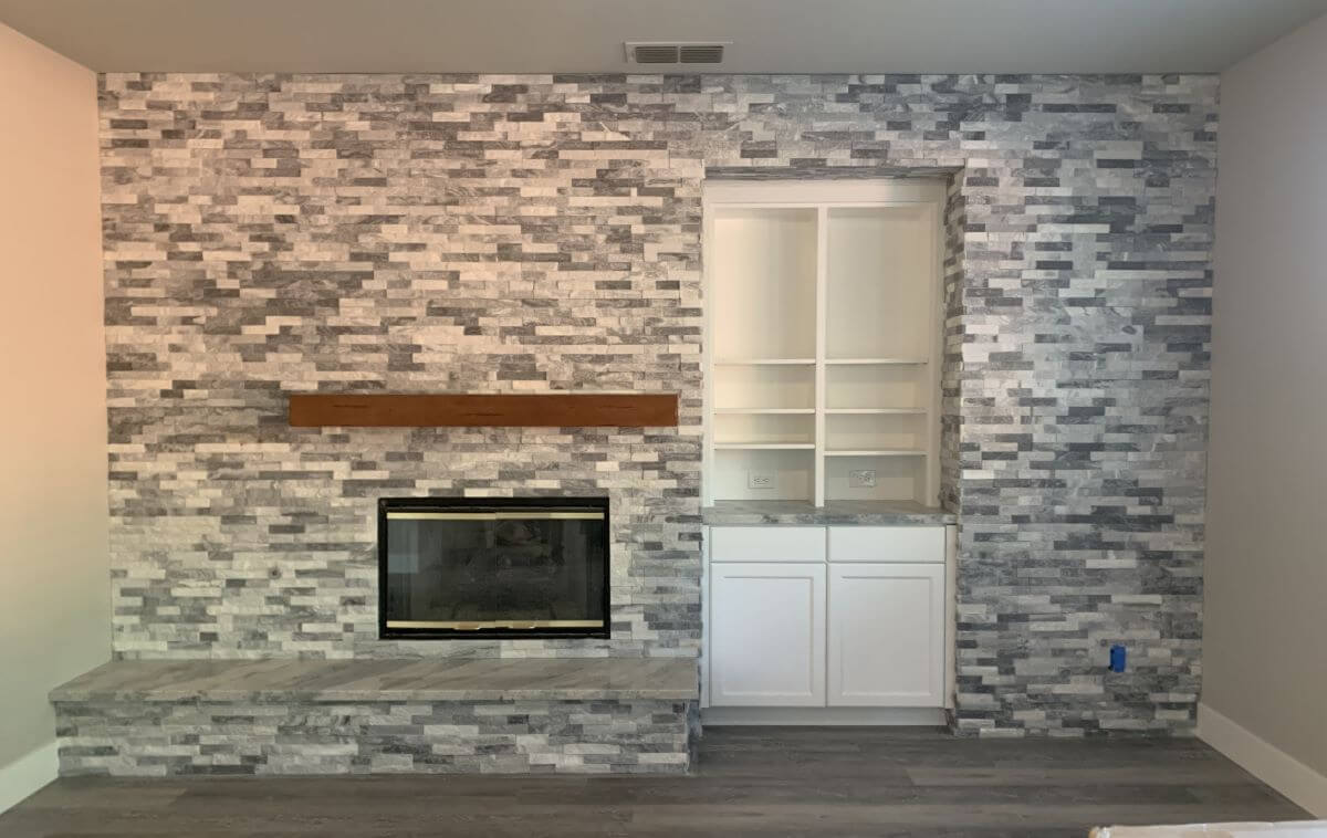 Stacked stone veneer ledger fireplace.