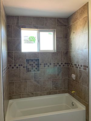 Tub surround with variable size tiles.